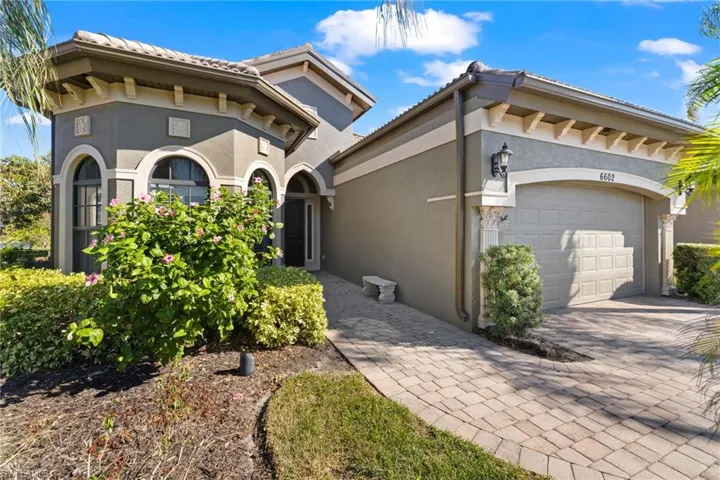 Mediterranean / spanish-style home with a garage