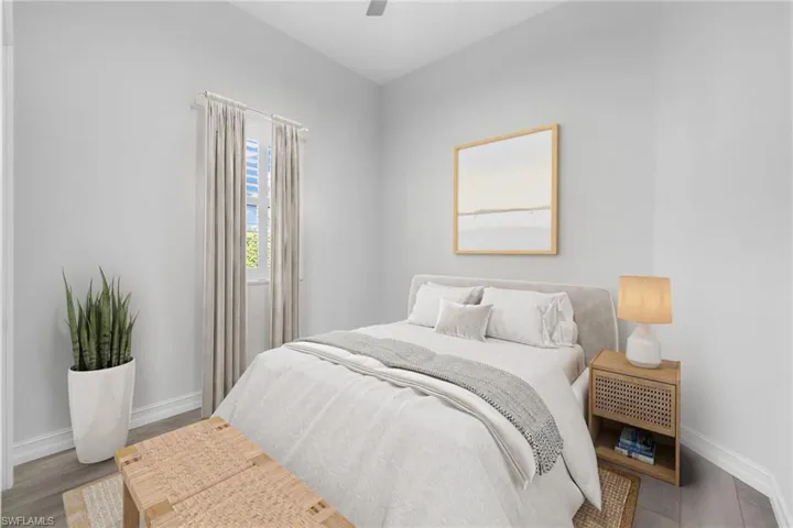 Bedroom featuring wood-type flooring and ceiling fan