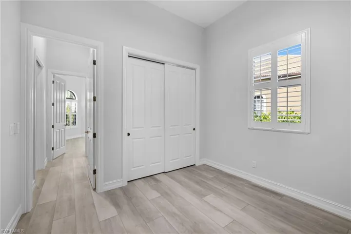 Unfurnished bedroom with light wood-type flooring and a closet