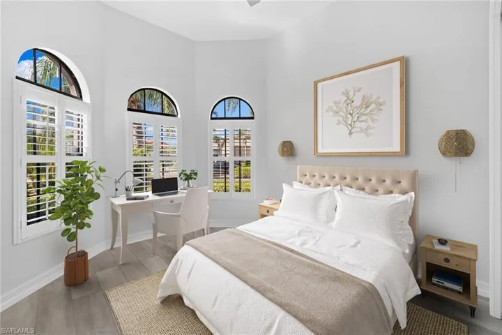 Bedroom featuring hardwood / wood-style floors and high vaulted ceiling