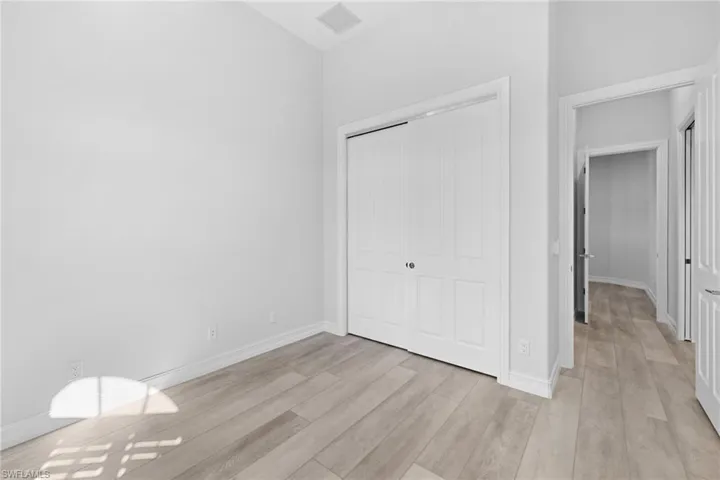 Unfurnished bedroom with light hardwood / wood-style flooring and a closet