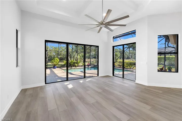Unfurnished room with ceiling fan, a healthy amount of sunlight, and light wood-type flooring