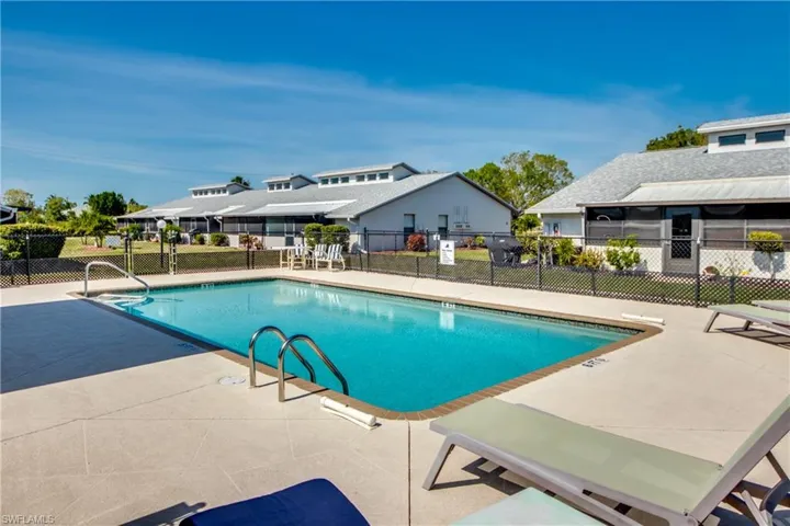 Community pool with a patio