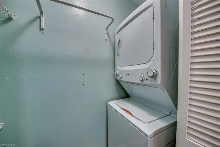 Laundry area featuring stacked washer and clothes dryer