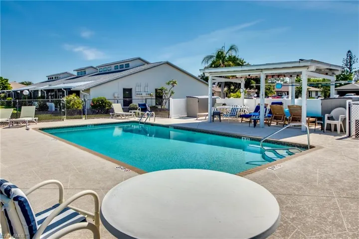Community pool with a patio area and a gazebo