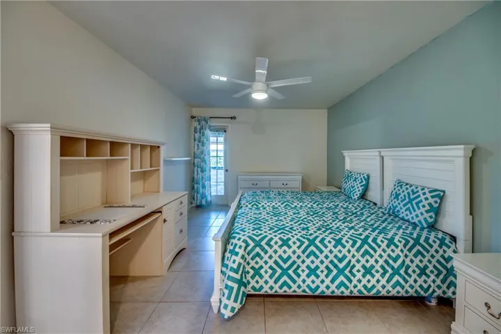 Bedroom with light tile patterned flooring and a ceiling fan