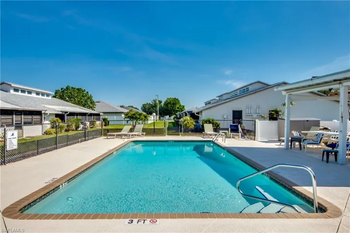 Community pool with a patio