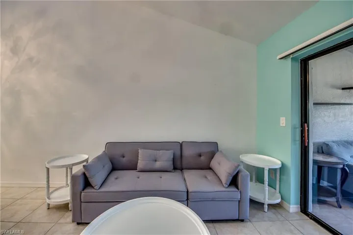 Living room featuring light tile patterned flooring and baseboards