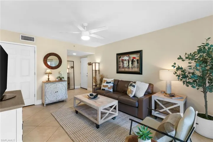 Tiled living room featuring ceiling fan