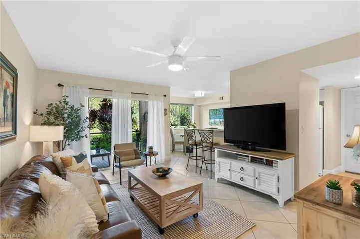 Tiled living room featuring ceiling fan