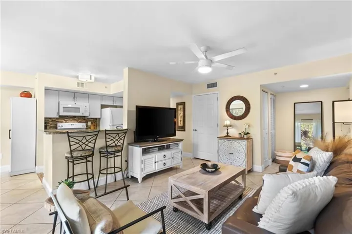 Tiled living room featuring ceiling fan