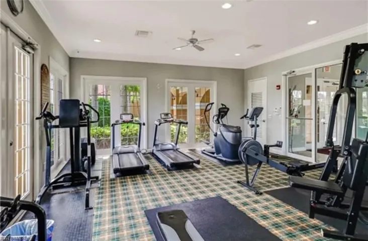 Workout area with ceiling fan, crown molding, and french doors