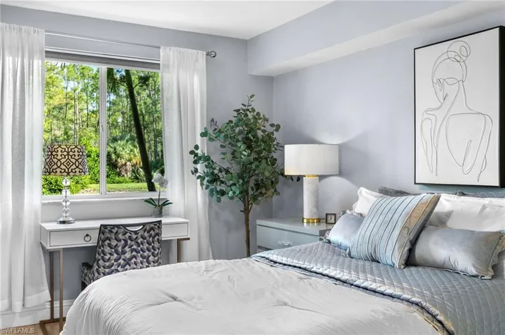 Bedroom with hardwood / wood-style floors and multiple windows