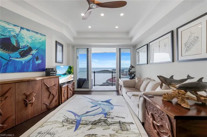 Living room with ceiling fan and recessed lighting