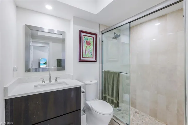 Full bath featuring a stall shower, vanity, and recessed lighting