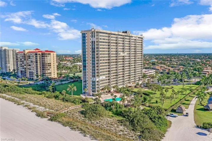 Drone / aerial view of a pool area and apartment complex