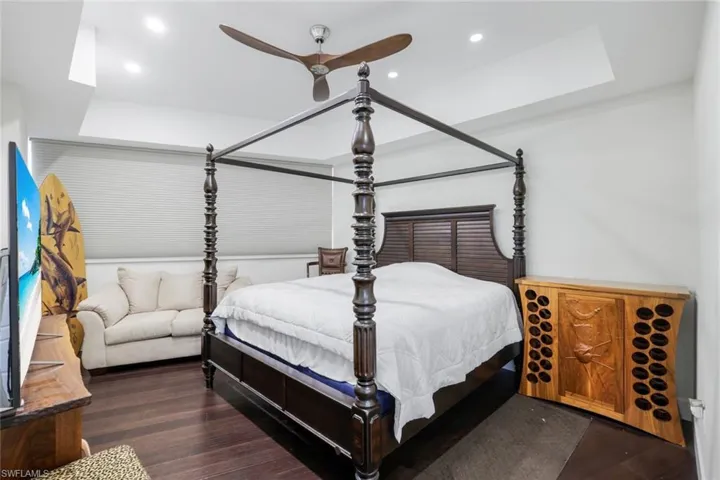 Bedroom with recessed lighting, a ceiling fan, and dark wood-type flooring