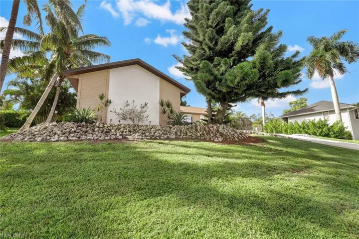 View of side of property with a yard