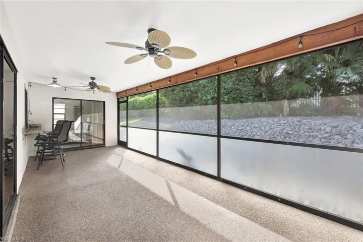 Unfurnished sunroom with ceiling fan