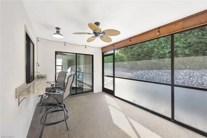 Unfurnished sunroom with ceiling fan
