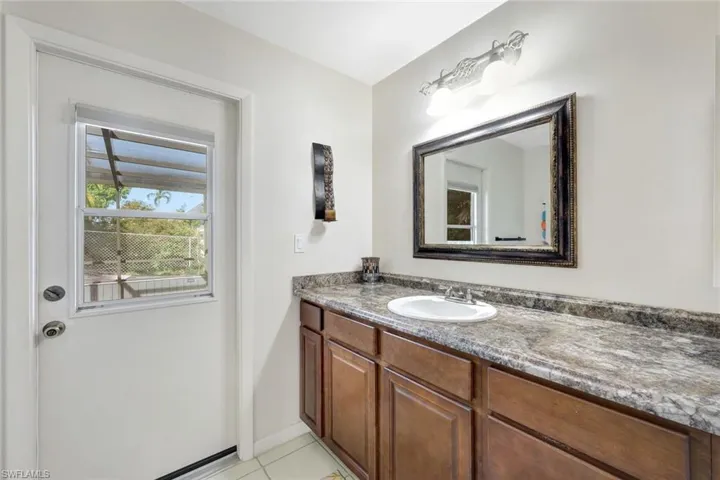 Bathroom with vanity and tile patterned floors