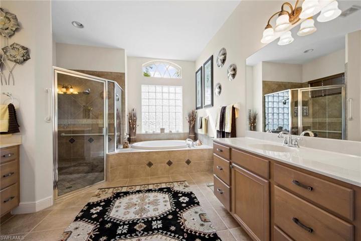 Master bath with dual vanities, large soaking tub, walk-in shower