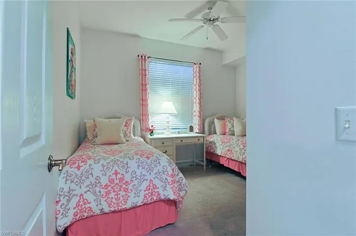 Carpeted bedroom with ceiling fan