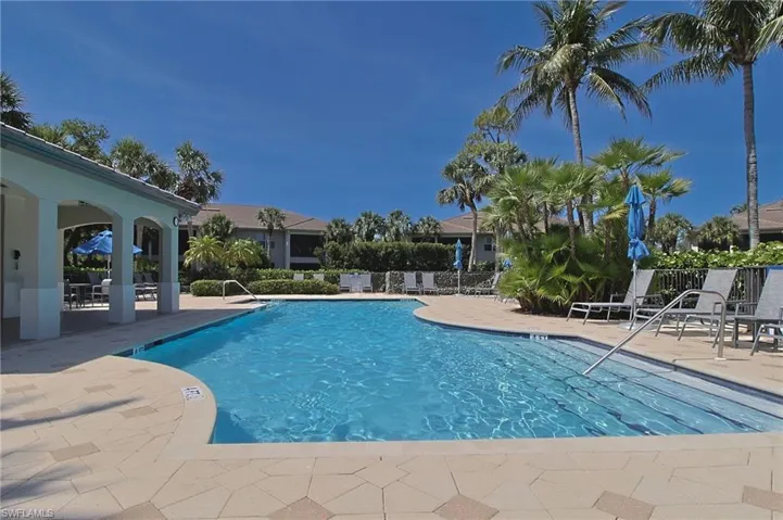 Community pool with a patio
