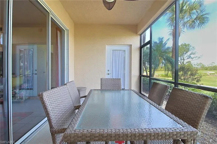 Sunroom with ceiling fan and outdoor dining area