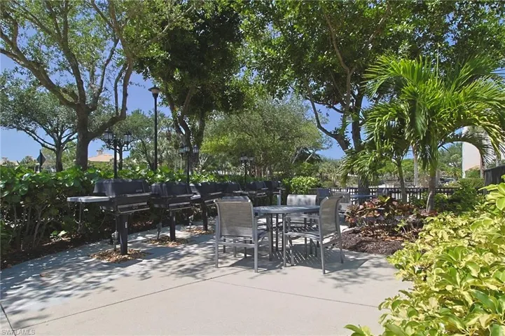 View of patio with fence, grilling area, and outdoor dining space