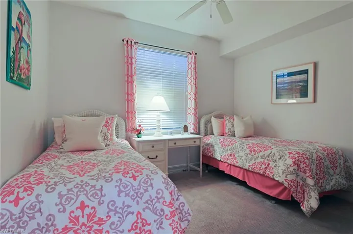 Carpeted bedroom with ceiling fan