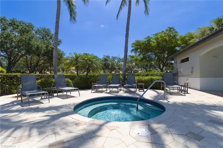 View of pool featuring a hot tub and a patio area