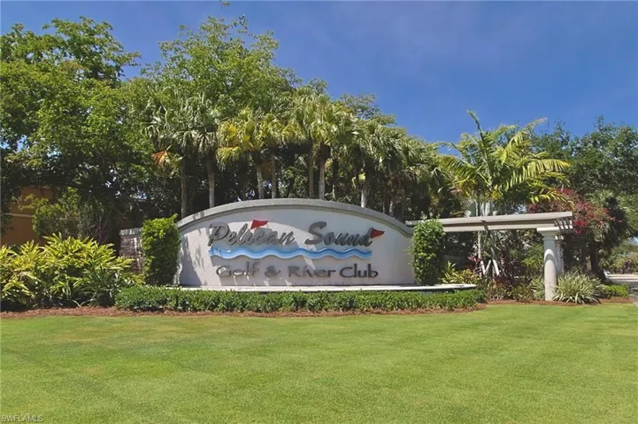 Community / neighborhood sign featuring a lawn