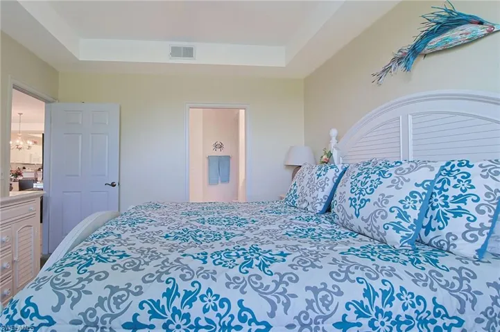 Bedroom with visible vents and a raised ceiling