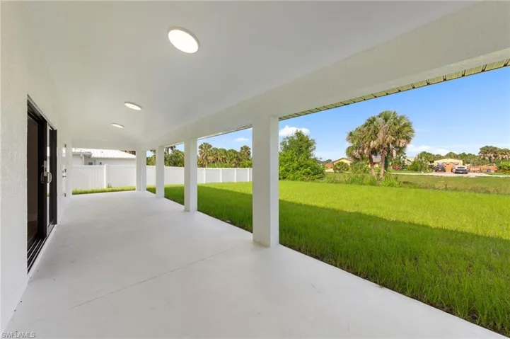 Expansive covered patio featuring a concrete surface, recessed lighting, and support columns