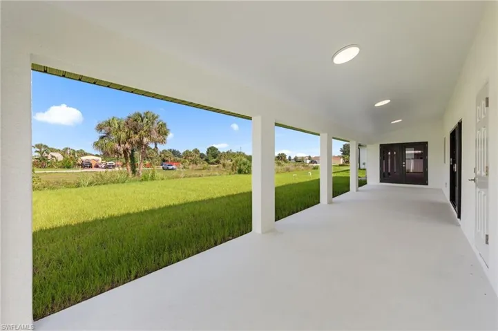Expansive covered patio featuring a concrete surface, recessed lighting, and support columns
