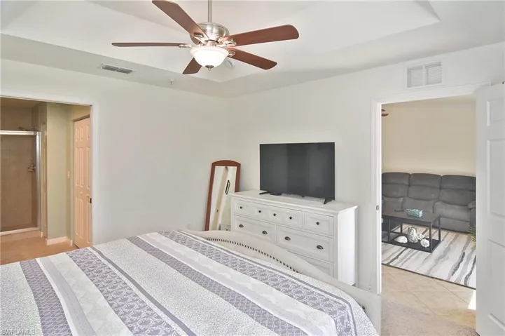Bedroom featuring light tile patterned flooring and ceiling fan