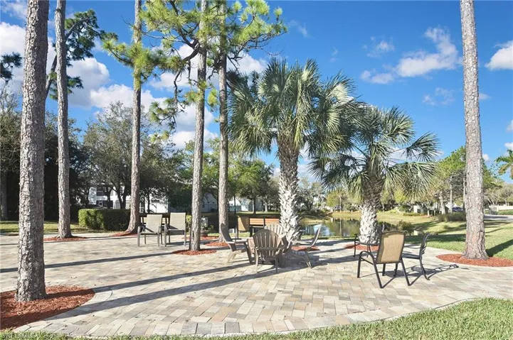 View of community with a water view and a patio area