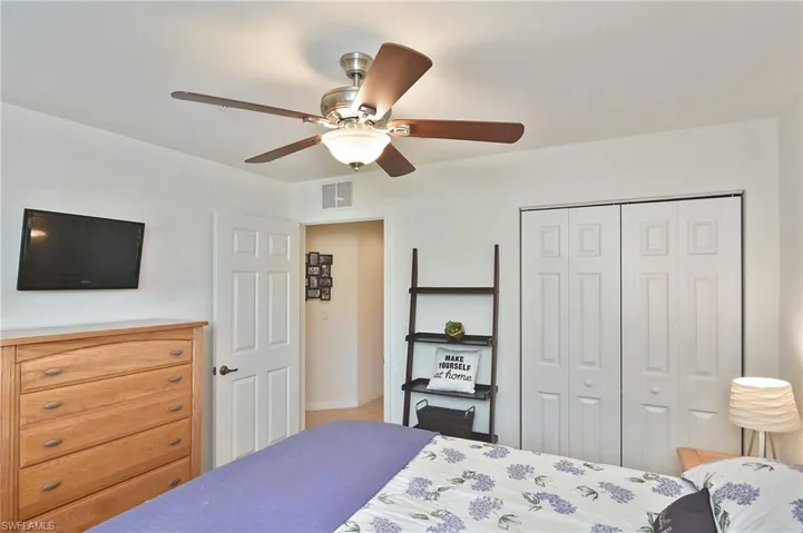 Bedroom featuring a ceiling fan and a closet