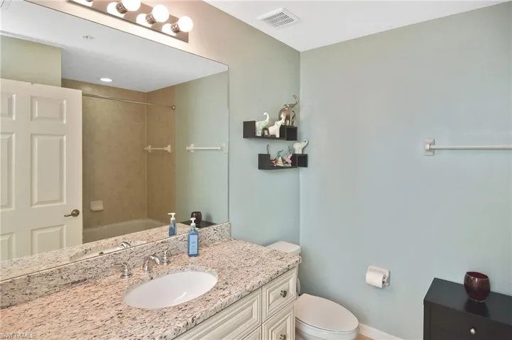 Bathroom with vanity and bathtub / shower combination