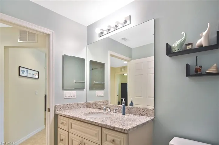 Bathroom with vanity and light tile patterned floors