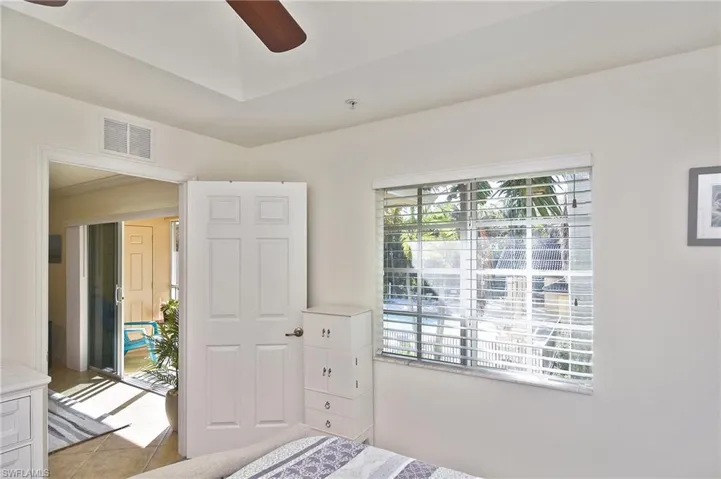Bedroom with ceiling fan and light tile patterned flooring