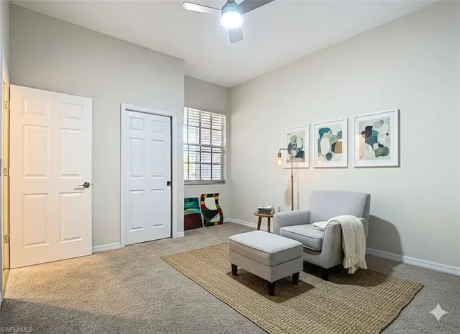 Second bedroom with carpet and a ceiling fan