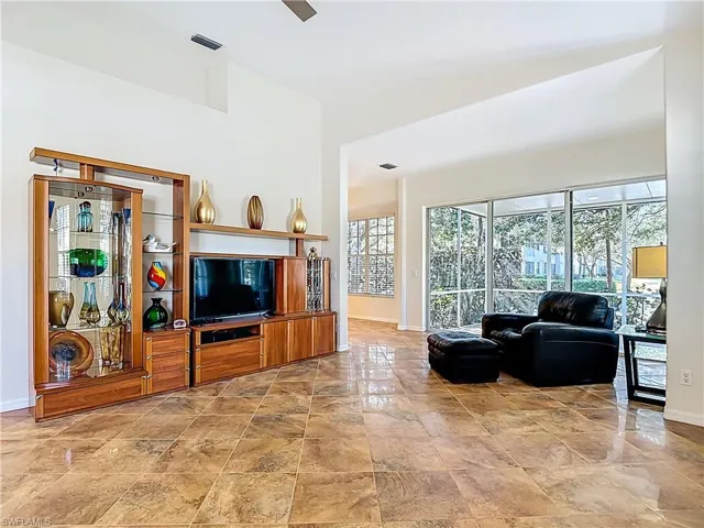 Living room featuring baseboards and a ceiling fan