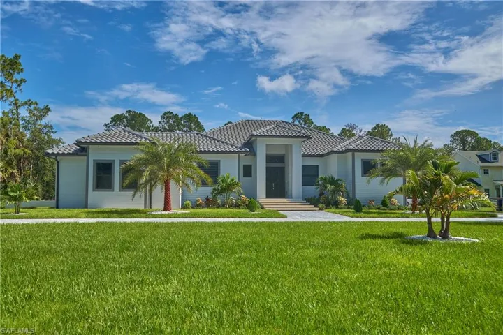 Mediterranean / spanish house with a front yard
