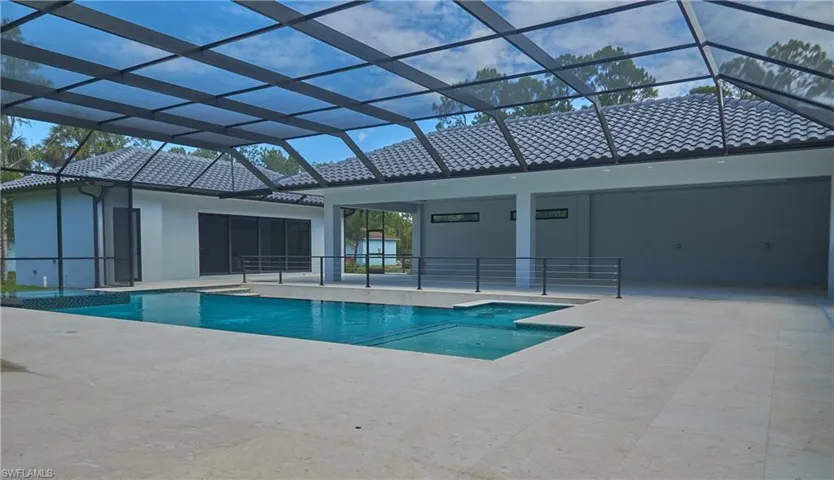 View of swimming pool featuring a patio and glass enclosure