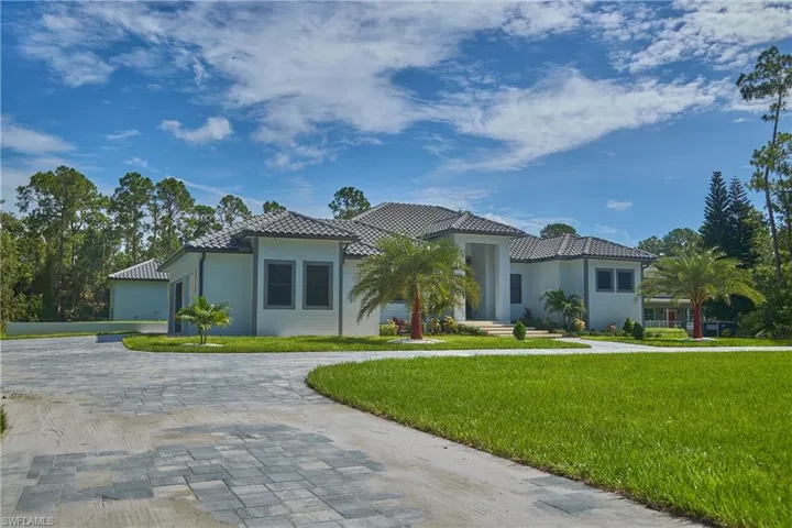 Mediterranean / spanish home with a garage and a front yard