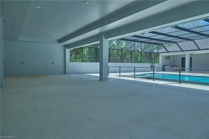 View of swimming pool featuring a patio and a lanai