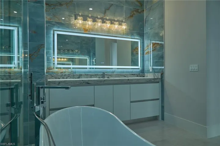 Bathroom featuring vanity and a bath