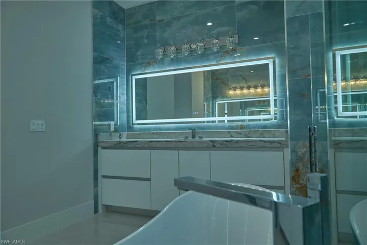 Bathroom featuring vanity and a tub to relax in